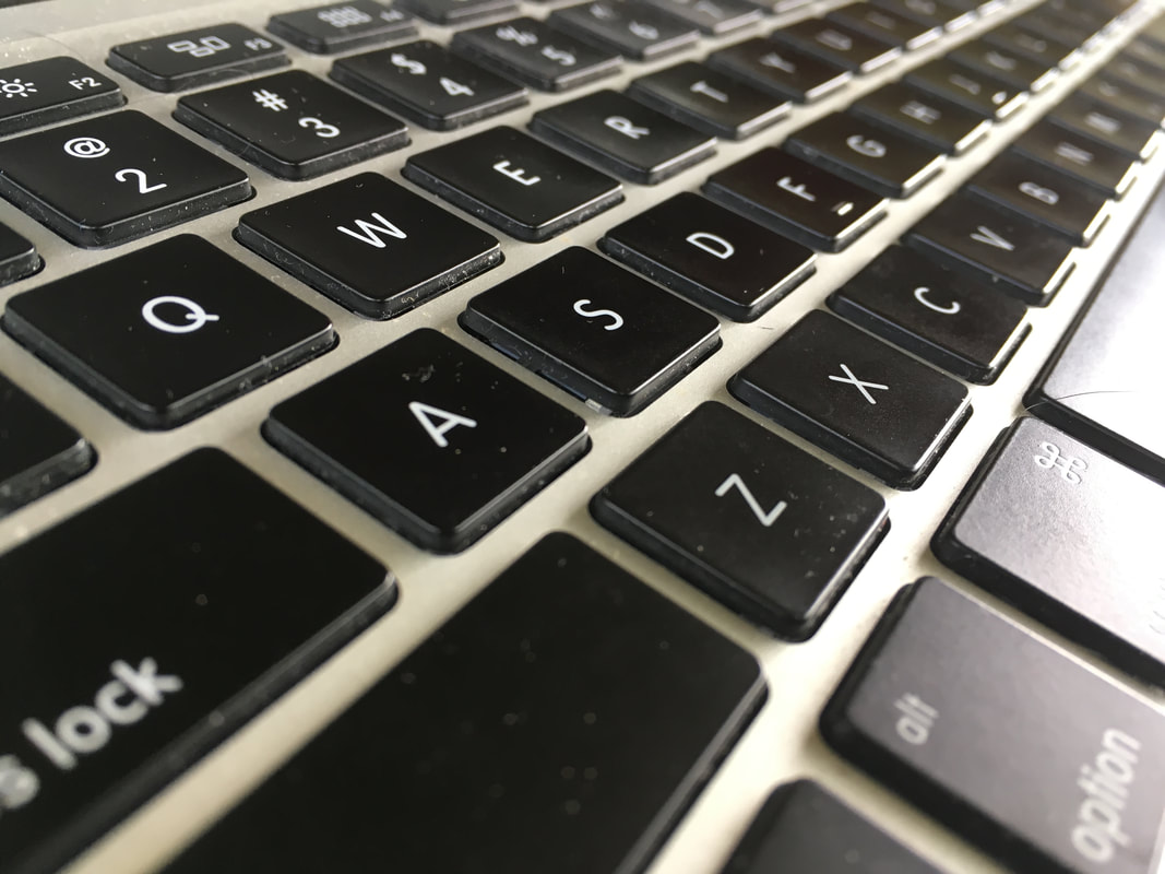 Closeup of a black and white keyboard at an angle
